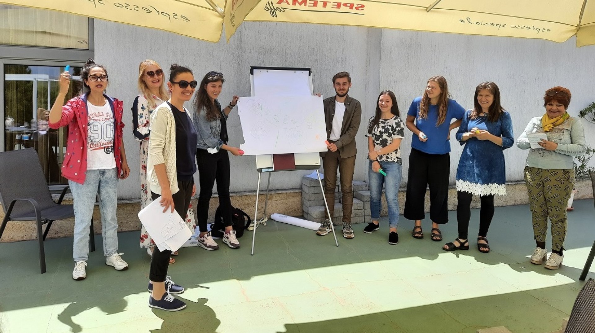 a group of people by a white board