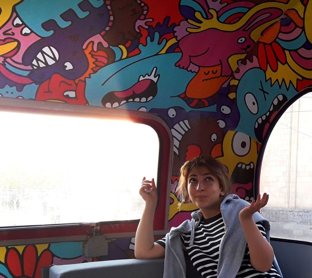 a girl on a colourful bus