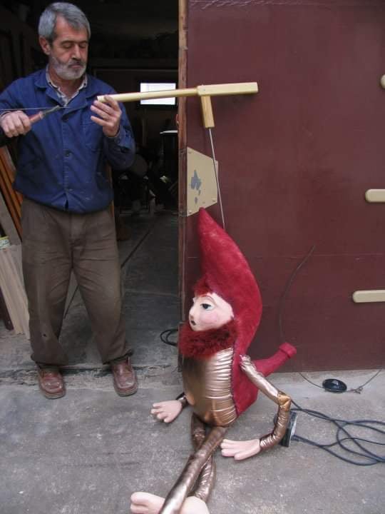 a man operates a marionette