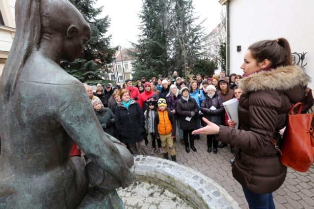 a tour guide with a blue tablet