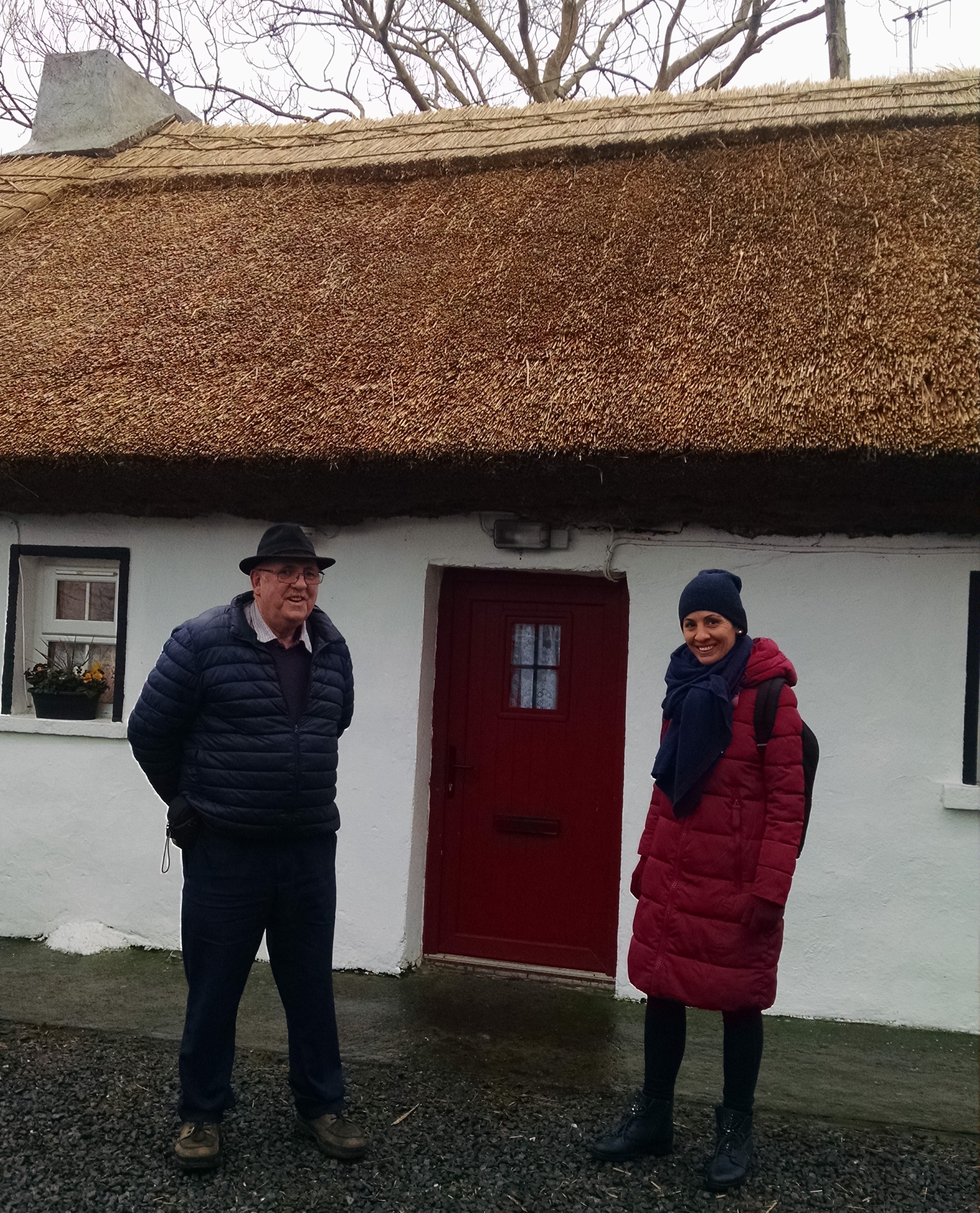 people by a thatched house