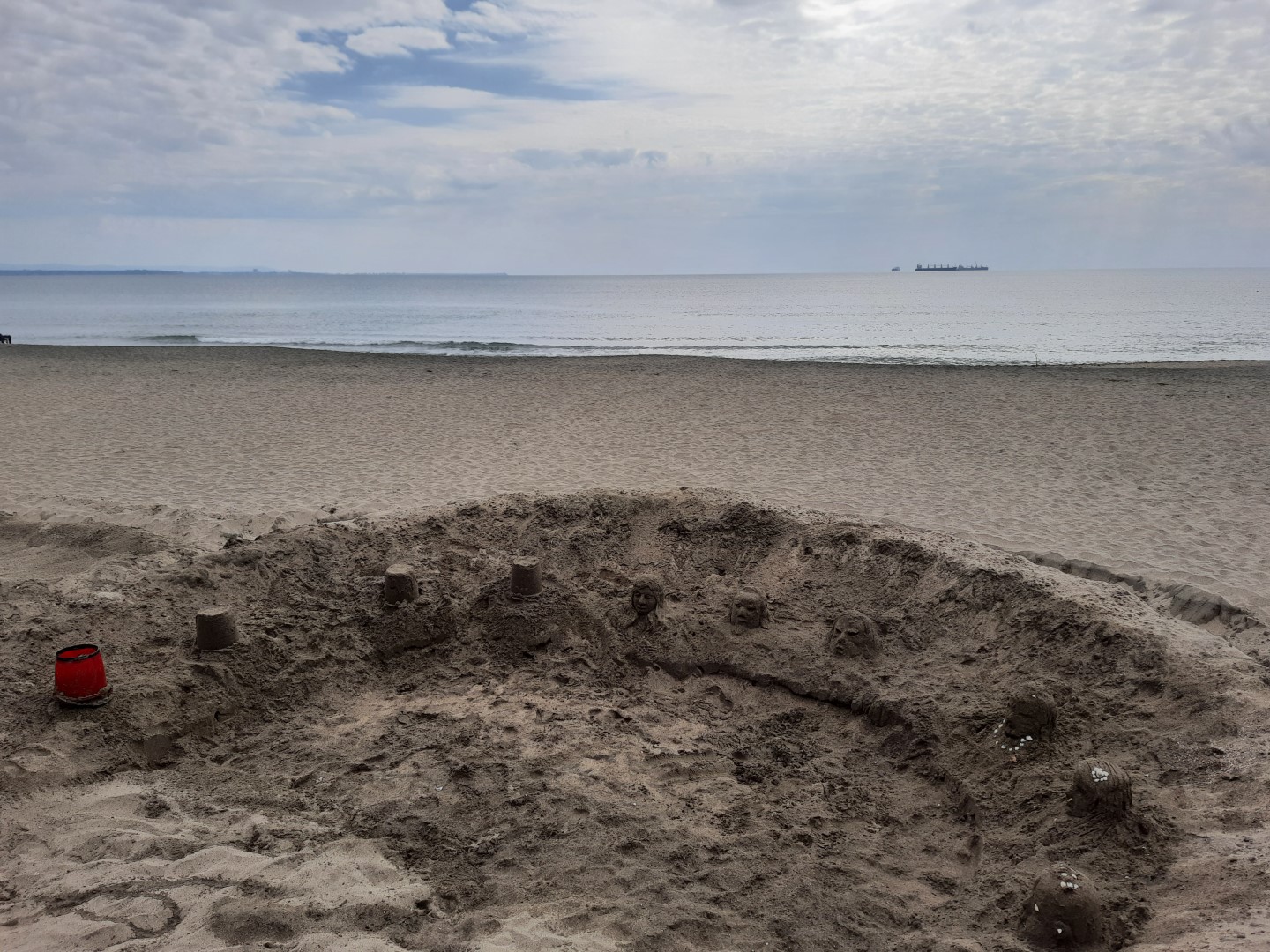 figures of sand on a beach