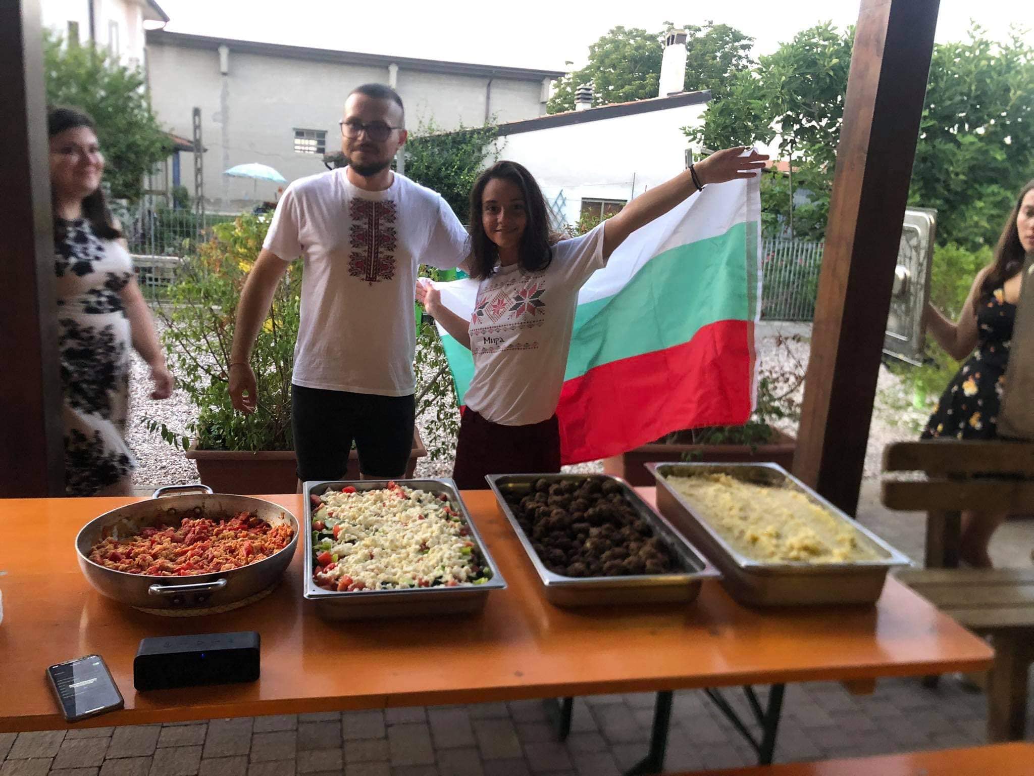 young people with different dishes in large containers